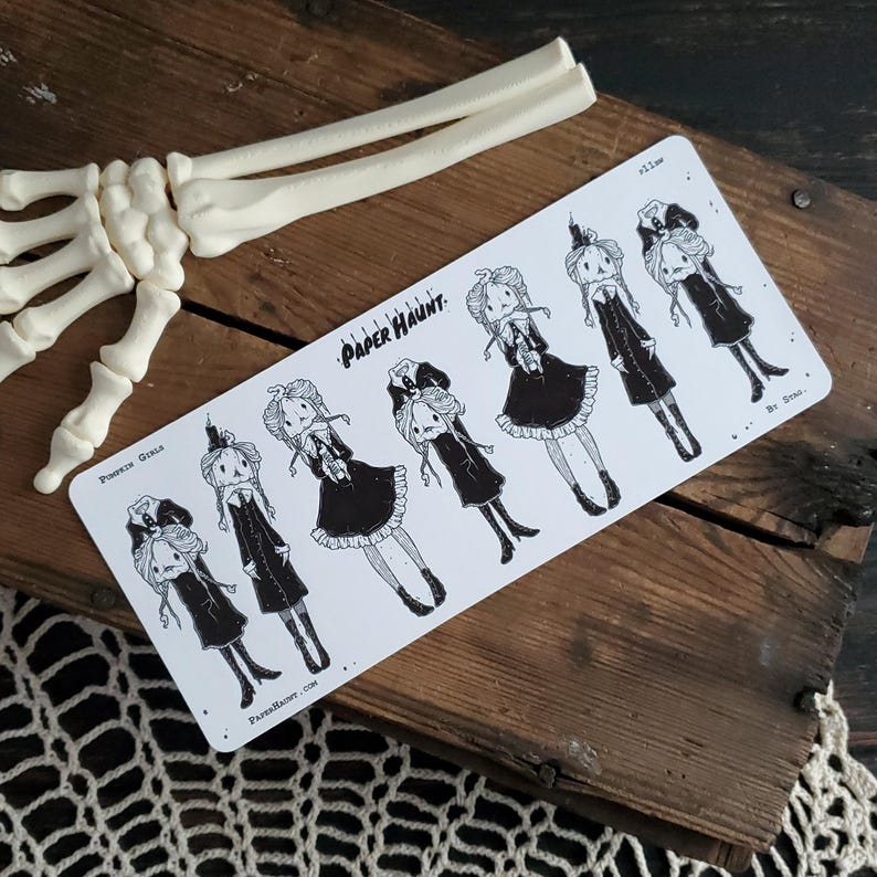 May include: A sheet of black and white stickers featuring illustrations of pumpkin girls in various poses. The stickers are labeled "Pumpkin Girls" and "Paper Haunt."