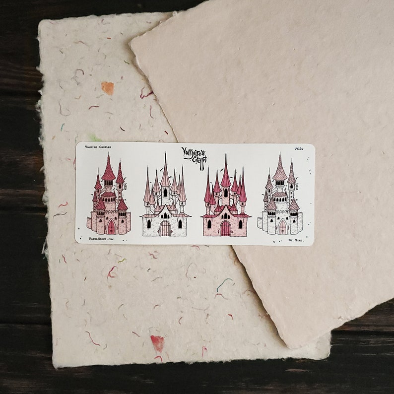 May include: A sticker sheet with four illustrations of pink and white castles. The sticker sheet is labelled "Vampire Castles" and "Yumi's Craft".