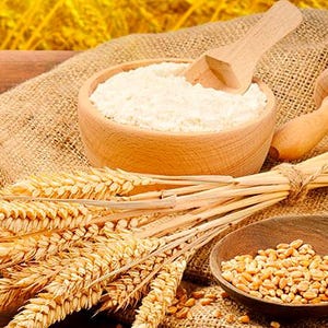 May include: A wooden bowl filled with white flour, a wooden spoon, a rolling pin, and wheat stalks on a burlap background.