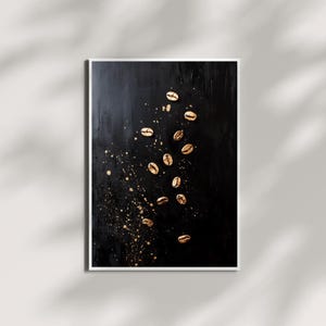 May include: Gold coffee beans scattered on a black background with gold paint splatters.