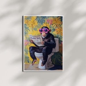 May include: A framed print featuring a chimpanzee wearing pink sunglasses and reading a newspaper titled "Monkey Dailly" while seated on a toilet. The background has a floral and foliage pattern in yellow, green, and pink.