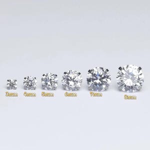 Op de afbeelding: Een verzameling van zes ronde, heldere edelstenen van verschillende groottes, variërend van 3 mm tot 8 mm in diameter. Elke steen is geplaatst tegen een lichte achtergrond, met de grootte van elke steen duidelijk aangegeven in millimeters.