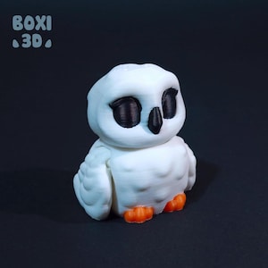 May include: A white 3D printed owl figurine with black eyes and orange feet. The owl is sitting on a black surface.