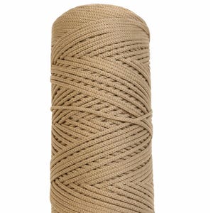 May include: A spool of tan 2mm polyester yarn, 220 meters in length, is shown against a white background. The yarn is tightly wound, with visible diagonal and horizontal lines. The text "2mm polyester yarn 220m" is at the top.