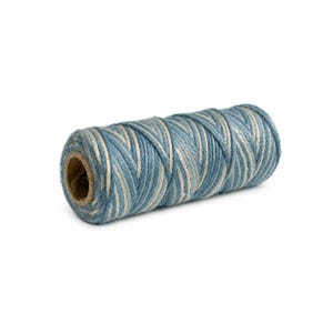 May include: A cylindrical spool of twine featuring a twisted, multi-strand design. The cord is composed of alternating fibers in shades of dusty blue and off-white, wound tightly around a central cardboard core to form a uniform, textured roll.