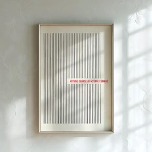 May include: A framed rectangular wall art print featuring a series of vertical gray lines on a cream background. The text "NOTHING CHANGES IF NOTHING CHANGES" is printed in red across the center, interrupting the pattern of the vertical lines.