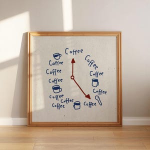 May include: A wooden framed artwork featuring a coffee-themed clock design. The clock face is white with blue handwritten text and illustrations of coffee cups and spoons. The clock hands are red, and the word "Coffee" is written around the clock face.