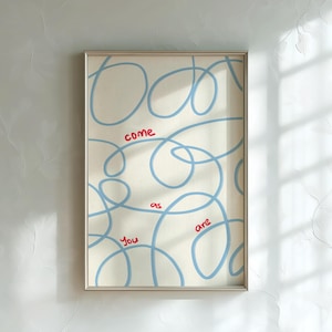May include: Framed art print with a cream background and blue swirling lines. The words "come as you are" are written in red. The artwork is encased in a silver frame.