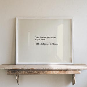 May include: A rectangular white picture frame containing a light beige background with black text that reads: Your Custom Quote Goes Right Here. - Add a Reference (optional). A thin vertical black line is positioned to the left of the text.