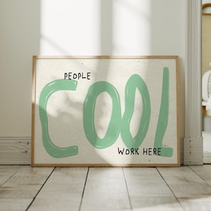 May include: A rectangular framed wall art piece featuring a light-colored textured background. The text reads PEOPLE COOL WORK HERE in black lettering, with the word COOL written in large, thick, light green brushstroke-style letters.