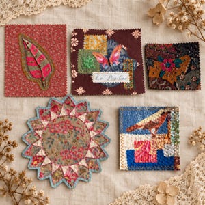 May include: Five fabric squares and shapes featuring mixed media textile art. Designs include a pink feather on red floral fabric, a butterfly with the text Le Papilion, a dark floral patch, a starburst floral quilt piece, and a bird on blue fabric.