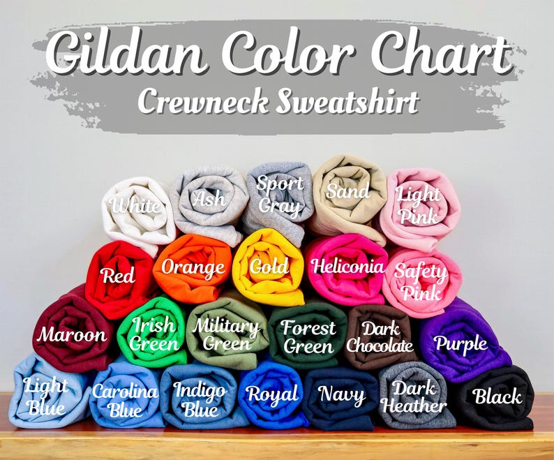 May include: A color chart for Gildan crewneck sweatshirts. The chart displays a variety of rolled-up sweatshirts in colors such as white, red, orange, and purple. The text "Gildan Color Chart Crewneck Sweatshirt" is at the top.