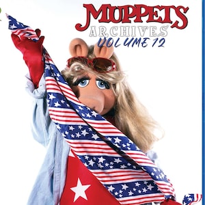 May include: A Blu-ray disc case for Muppets Archives Volume 12 featuring Miss Piggy wearing red gloves and a light blue shirt, draped in a red, white, and blue American flag scarf with stars and stripes, with red sunglasses atop her blonde hair.