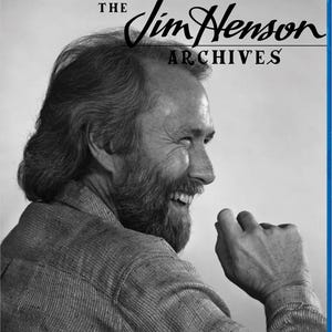 May include: Blu-ray disc case featuring a black and white image of Jim Henson, the creator of the Muppets. The title "The Jim Henson Archives" is displayed in elegant script above the image.