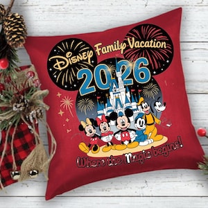 May include: Red decorative pillow featuring Disney characters and the text "Disney Family Vacation 2026". The pillow has a design of Mickey Mouse, Minnie Mouse, Goofy, and Donald Duck in front of a castle with fireworks.