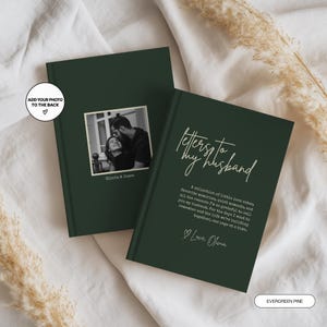 May include: Two dark green hardcover books. One features a black and white photograph of a couple with the text "Olivia & James" and a circular note "ADD YOUR PHOTO TO THE BACK". The other displays the text "Letters to my husband" and "Love, Olivia".
