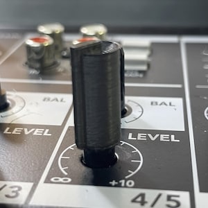May include: Close-up of a black knob with a silver level control dial labeled "LEVEL" and "BAL". The knob is on a black mixer with a silver faceplate.