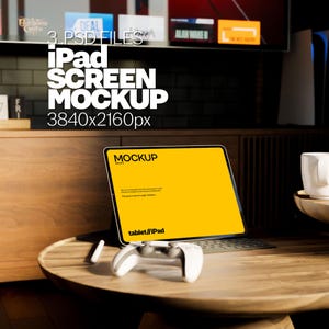 May include: A yellow iPad mockup with the text "MOCKUP" on the screen. The iPad is on a wooden table with a white game controller and a white stylus. The text "tablet/iPad" is visible on the screen.