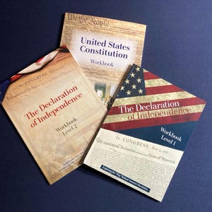May include: Three workbooks with patriotic themes. The covers feature the text "United States Constitution Workbook", "The Declaration of Independence Workbook Level 2", and "The Declaration of Independence Workbook Level 1". The covers have an aged paper look with American flag imagery.