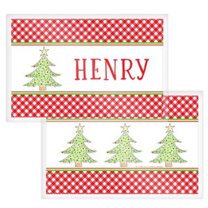 May include: Christmas-themed placemats with a red and white checkered border and a green and white stripe. One placemat features the name "HENRY" in red, while the other has three Christmas trees. The trees are green with yellow star toppers.