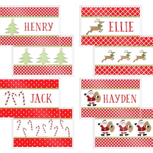 May include: Christmas-themed name tags with red and white patterns. Each tag features a name in red, along with festive illustrations: Christmas trees, reindeer, candy canes, and Santa Claus. The tags are rectangular with a white border.