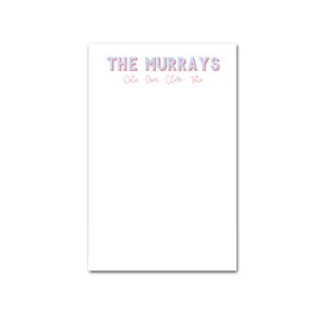 May include: A white notepad with the text "THE MURRAYS" in blue and pink letters. Below the text, the names "Cate, Sam, Clare, Tate" are written in pink.