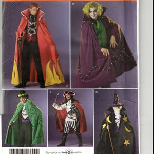 May include: A sewing pattern sheet featuring five costume designs: a red devil cape with yellow flames, a purple cape with green accents, a green cape with swirl patterns, a red and white pirate outfit, and a black wizard cape with yellow stars.