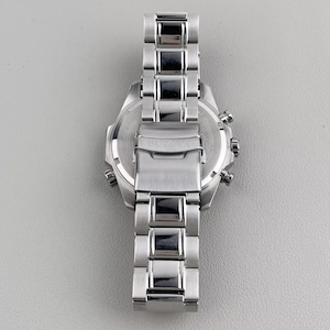 May include: A stainless steel Bulova watch with a silver band and a round face. The watch features a chronograph design with multiple dials and buttons. The band is composed of rectangular links.
