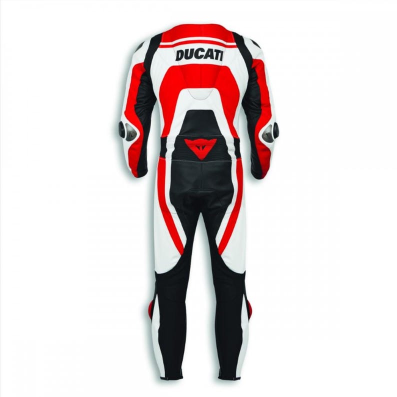 May include: A Ducati racing suit in white, red, and black. The suit features the Ducati logo on the back and protective padding on the shoulders and knees. The suit is designed for motorcycle racing and is made of leather.