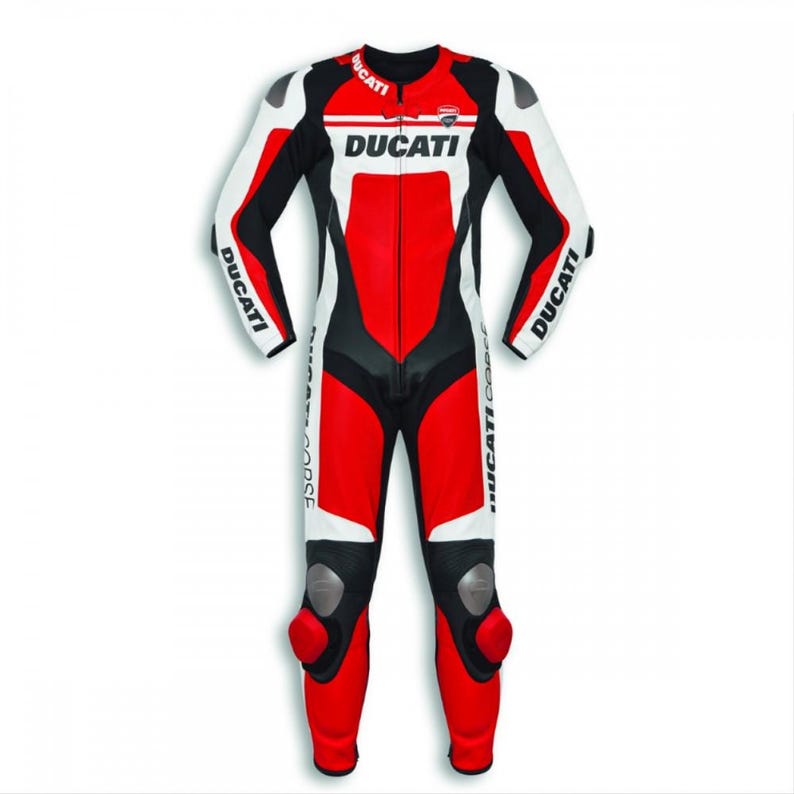 May include: A red, white, and black Ducati motorcycle racing suit. The suit features the Ducati logo across the chest and on the sleeves. The suit has protective padding on the knees and elbows.