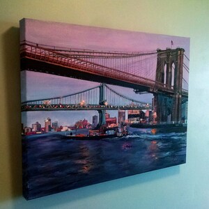May include: A painting of the Brooklyn Bridge in New York City at dusk. The bridge is lit up with lights and there are boats in the water below. The sky is a soft purple and pink.