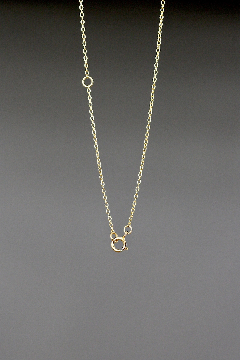 May include: A gold chain necklace with a lobster clasp closure.