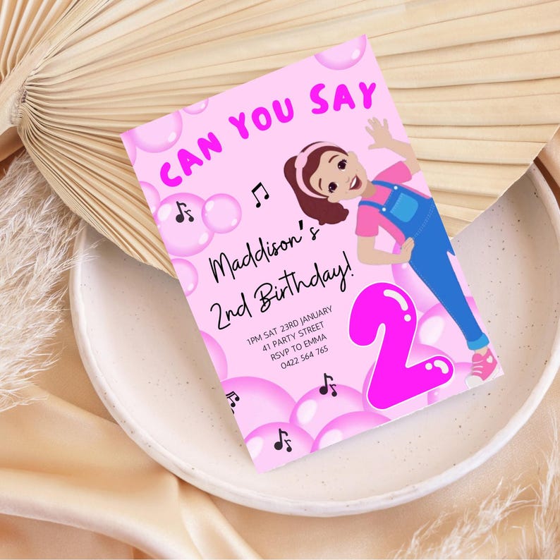 May include: Pink birthday invitation with a cartoon girl in overalls and a pink number 2 balloon. The text reads "Can you say Maddison's 2nd Birthday!" with details for the party.