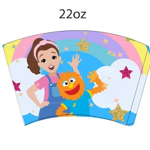 May include: A 22oz paper cup featuring a cartoon illustration of a woman and a furry orange character with a rainbow, stars, and clouds. The woman wears a pink shirt and blue overalls. The orange character wears a blue shirt.