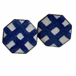 May include: A pair of octagonal shaped earrings with a blue and white checkered pattern.