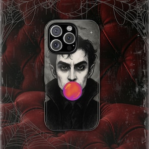 May include: A clear phone case featuring a stylized illustration of a vampire with a bubblegum bubble. The vampire has dark hair, pale skin, and is wearing a black collared shirt. The background is a dark, gothic-themed design.