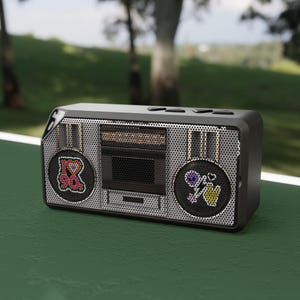 May include: A black and silver boombox with decorative patches. The patches include a heart with the text "I ❤️ 90s" and a flower with a peace sign. The boombox has a mesh speaker cover and a retro design.