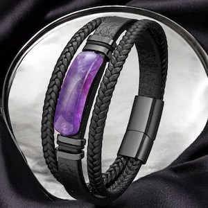 May include: A black leather bracelet with a braided design and a purple stone accent.