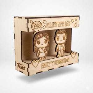 Puede incluir: Un expositor de madera para el Día de San Valentín con dos figuras Funko Pop de una pareja. La caja expositora es de madera clara e incluye el texto "Valentine's Day" y "Emily y Sebastian".