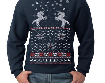 May include: Navy blue sweatshirt with a festive design. The sweater features two white unicorns, snowflakes, and a pattern of red and white snowflakes, reindeer, and Christmas trees. The sweatshirt is a crew neck style.