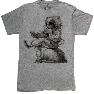 Mens unisex T-shirt - ASTRONAUT READING BOOK ---- sizes sm med lg xl xxl