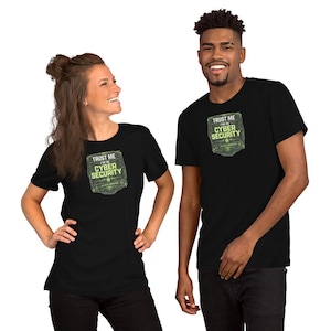 May include: Two people wearing black t-shirts. Each shirt has a green and white graphic that reads "Trust Me I'm in Cyber Security". The shirts are short-sleeved and appear to be made of a soft material.