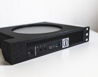 May include: A black Dell OptiPlex 7050 computer with a mesh front panel and various ports. The computer has a circular opening on top and the Dell logo on the side. The text "OptiPlex 7050" is visible.