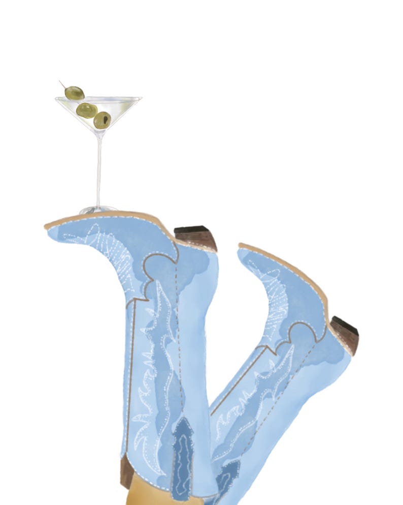 May include: A pair of light blue cowboy boots with intricate stitching, one boot is holding a martini glass with olives.