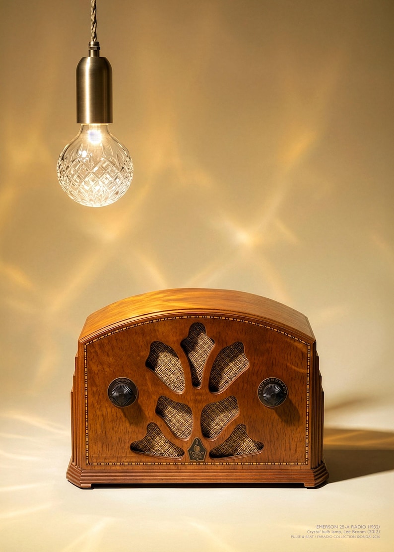 May include: A vintage wooden radio with a decorative front panel and two knobs. Above, a crystal bulb lamp hangs from a cord. The radio is labeled "EMERSON 25-A RADIO (1932)" and the lamp is labeled "Crystal bulb lamp. Lee Broom (2012)".