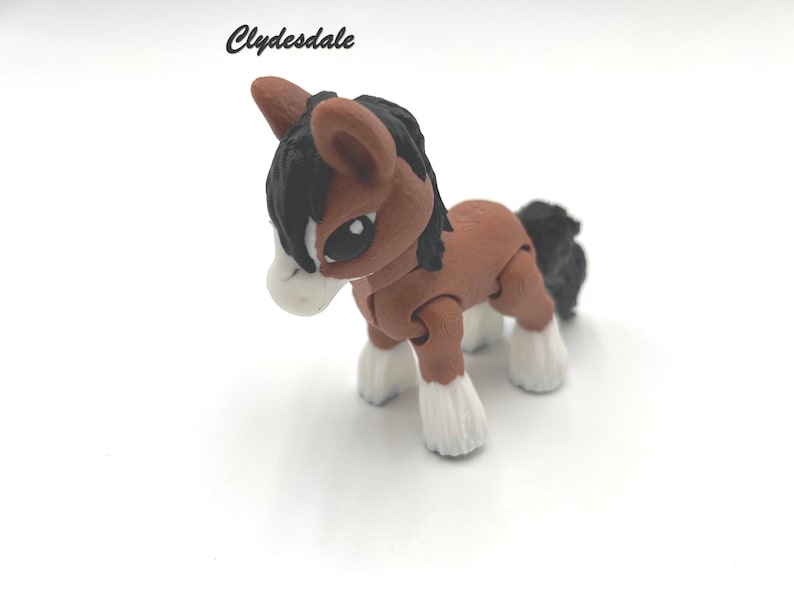 May include: A brown and black Clydesdale horse figurine with white hooves. The figurine is made of plastic and has a jointed head, legs, and tail.
