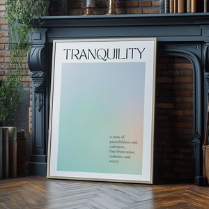 May include: Framed art print with the word "TRANQUILITY" at the top. The background has a soft gradient of blue, green, and peach. Below the word is the definition of tranquility: a state of peacefulness and calmness, free from noise, violence, and worry.