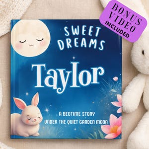May include: A children's book titled "Sweet Dreams Taylor" with a blue cover featuring a smiling moon, a white bunny, and pink flowers. The book includes a bonus video. A plush bunny is in the background.
