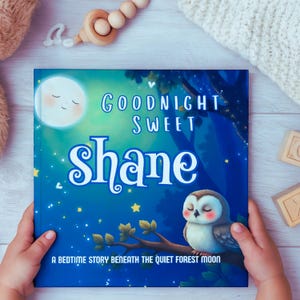 May include: A children's book titled "Goodnight Sweet Shane" with a blue cover featuring a moon, an owl, and the text "A bedtime story beneath the quiet forest moon." The book is held by a child.