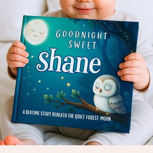May include: A children's book with a dark blue cover featuring the text "GOODNIGHT SWEET Shane" in white script. An illustration of a moon, stars, and an owl on a branch is also visible. The book's title is "A BEDTIME STORY BENEATH THE QUIET FOREST MOON".